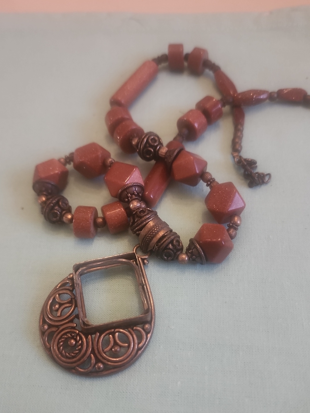 Red Goldstone Bead Necklace with Ornate Copper Pendant